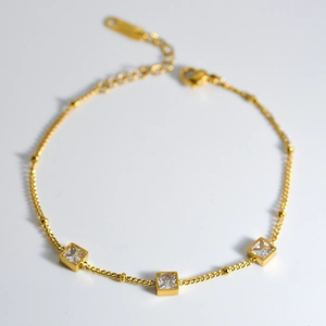 Elegant gold stainless steel bracelet featuring square clear zircon stones and adjustable clasp