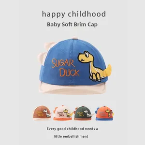 Detail of baby soft brim hats featuring Sugar Duck embroidery and dinosaur patches