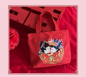 Close-up of red wedding canvas tote bag with cartoon couple and festive Xi character