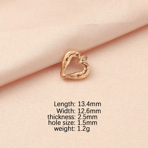 Detailed size chart of gold heart pendant with dimensions and weight on pink silk fabric