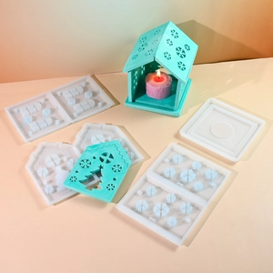 Macro detail of silicone mold set for 3D Christmas house with snowflake and tree patterns