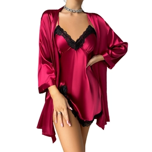 Women's red satin sleepwear set with black lace trim and matching long sleeve robe