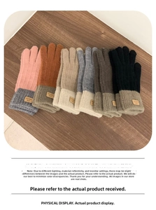 Knitted winter gloves in assorted colors with touchscreen fingertips on a wooden table