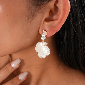 Close-up of pearl petal earring with crystal diamond stones on female model
