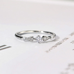 Detailed view of silver zircon ring showing claw-set stones and minimalist craftsmanship