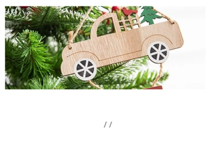 Close-up of vintage wooden truck ornament with Christmas tree hanging on a pine branch