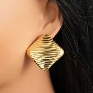 Detailed macro shot of 18K gold stainless steel earrings with textured starfish pattern