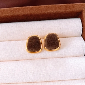 Vintage deep brown flocked round stud earrings with gold metal frame in a jewelry box