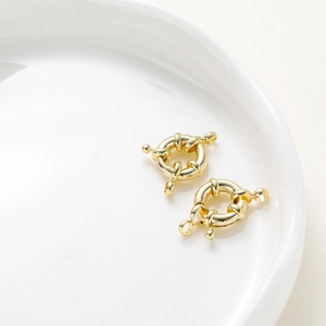 Macro shot of two 14K gold plated spring ring clasps for DIY jewelry necklaces