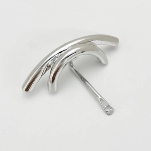 Detailed macro view of silver minimalist U-shaped hair clip with smooth polished finish