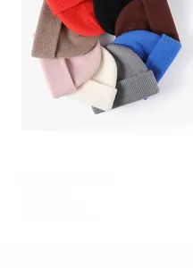 Detail showing various colors of fine knit beanies with ribbed texture and elastic design