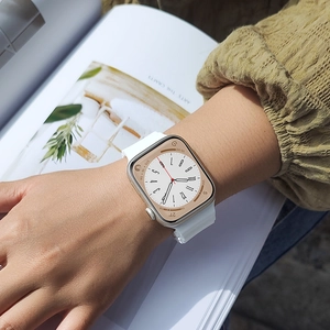 White ocean silicone strap on a gold smartwatch worn on a wrist against a lifestyle background