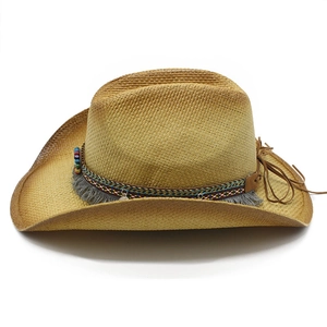 Detail of ethnic western cowboy straw hat with colorful beads and grey tassel trim