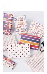 Detail of colorful gift wrapping paper featuring stars, stripes, hearts and birthday motifs