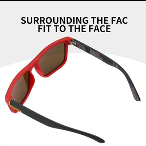 Detail view of polarized sports sunglasses with red frame and camouflage pattern on temples