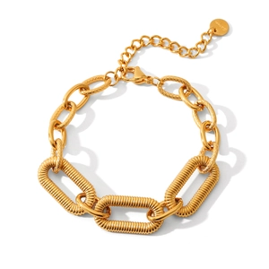 Detail of gold stainless steel cuban chain bracelet showing lobster clasp and S.steel tag