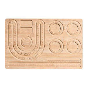 Detailed top view of wooden jewelry design board with engraved measurements and sorting slots