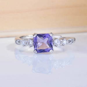 Princess cut amethyst ring with side stones on a minimalist silver band
