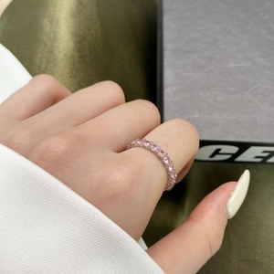 Detailed close-up of a sterling silver ring with sparkling pink cubic zirconia stones