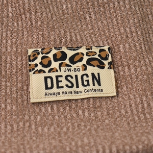 Brown waffle knit beanie with leopard print design patch and stylish logo detail