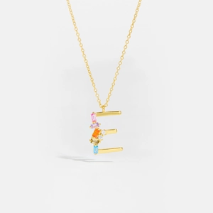 Macro detail of gold S925 silver letter E pendant with vibrant colorful zircon stones