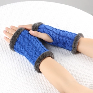 Detail of blue cable knit fingerless gloves with soft grey faux fur trim and cuffs
