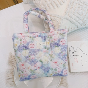 Detail of floral quilted tote bag with pink roses and lavender hydrangea prints
