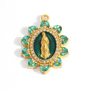 Detailed macro view of gold-plated Virgin Mary pendant with green enamel and crystals