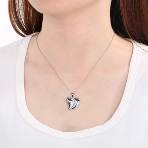 Polished silver heart pendant necklace in stainless steel on neck for women
