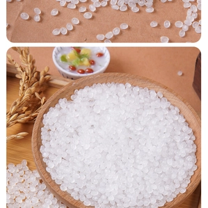 Detailed view of translucent white faux rice beads in a wooden bowl for DIY crafts