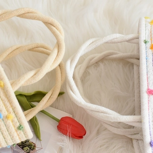 Fashionable woven cotton rope tote bag with twisted handles and colorful dot accents