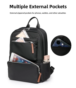 Detail of black waterproof backpack showing multiple zippered pockets and storage capacity