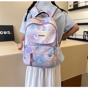 Detail of purple gradient backpack featuring aesthetic moon and butterfly prints