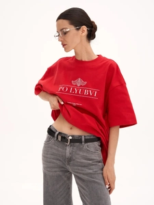 Detail of red cotton T-shirt showing relaxed fit hem and PO LYUBVI graphic print