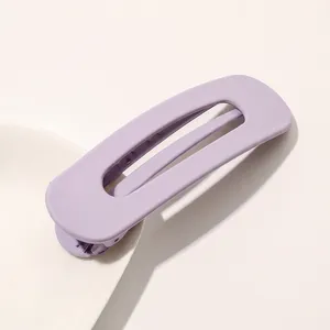 Detail of matte Morandi pink hollow rectangular hair clip with smooth rounded edges