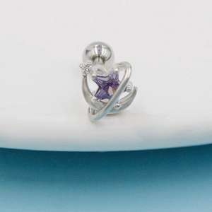 Detail of silver cartilage stud featuring purple star gemstone and moon orbital design