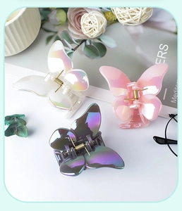 Three elegant butterfly hair claws in white, pink and iridescent shades with pearl luster