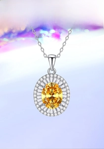 Macro detail of oval yellow gemstone pendant with double-layered diamond halo setting