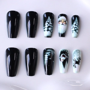 Christmas press-on nails featuring black reindeer, Santa, and tree designs on long coffin nails