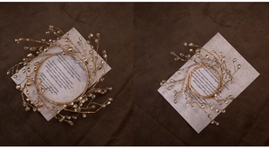 Macro detail of two golden beaded branch wreaths with sparkling crystal droplets