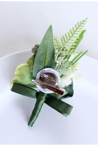 Detail of green PE rose wedding boutonniere with secure safety pin and clip attachment