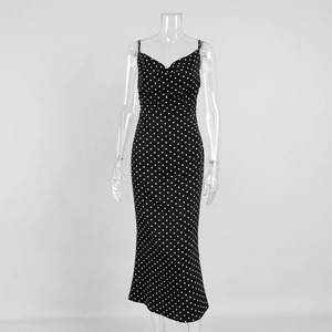 Close-up of vintage black polka dot maxi dress with elegant fishtail hem and slim fit