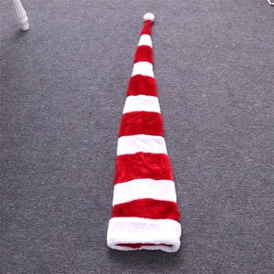 Detailed view of the 1.3m extra long red and white striped plush Christmas hat on grey floor