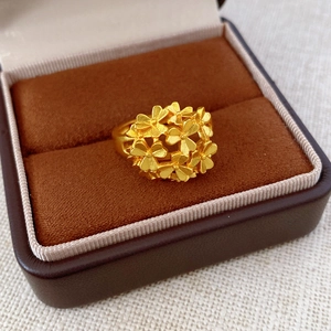 Macro shot of matte 24k gold plated flower ring nestled in a premium jewelry box