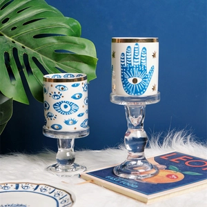 Ceramic Hamsa Hand and Evil Eye candle holders with gold rim on glass bases