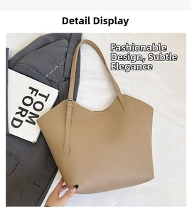 Detail view of large brown pebble leather tote bag with unique V-shaped opening design