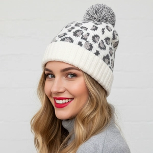 Women's leopard print knit beanie with gray faux fur pom-pom and ribbed cuff