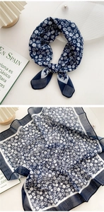 Close-up of navy blue floral cotton linen scarf showing fabric texture and tied knot