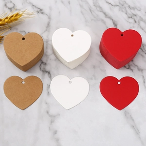 Brown white and red heart-shaped paper tags on marble surface with wheat decor
