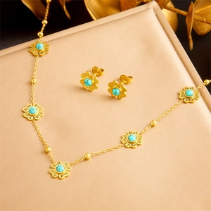 Vintage gold turquoise jewelry set with flower necklace and earrings on satin